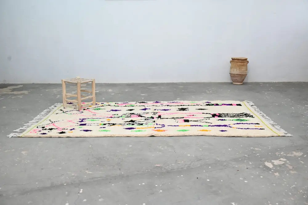 DecorBites™ moroccan handmade traditional azilal rug with cream base and vibrant geometric patterns in pink and green