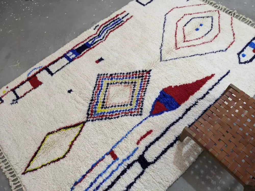 Cream-colored DecorBites™ moroccan handmade traditional azilal rug with bold red blue yellow and black geometric patterns 300x200 cm