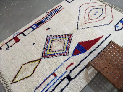 Cream-colored DecorBites™ moroccan handmade traditional azilal rug with bold red blue yellow and black geometric patterns 300x200 cm