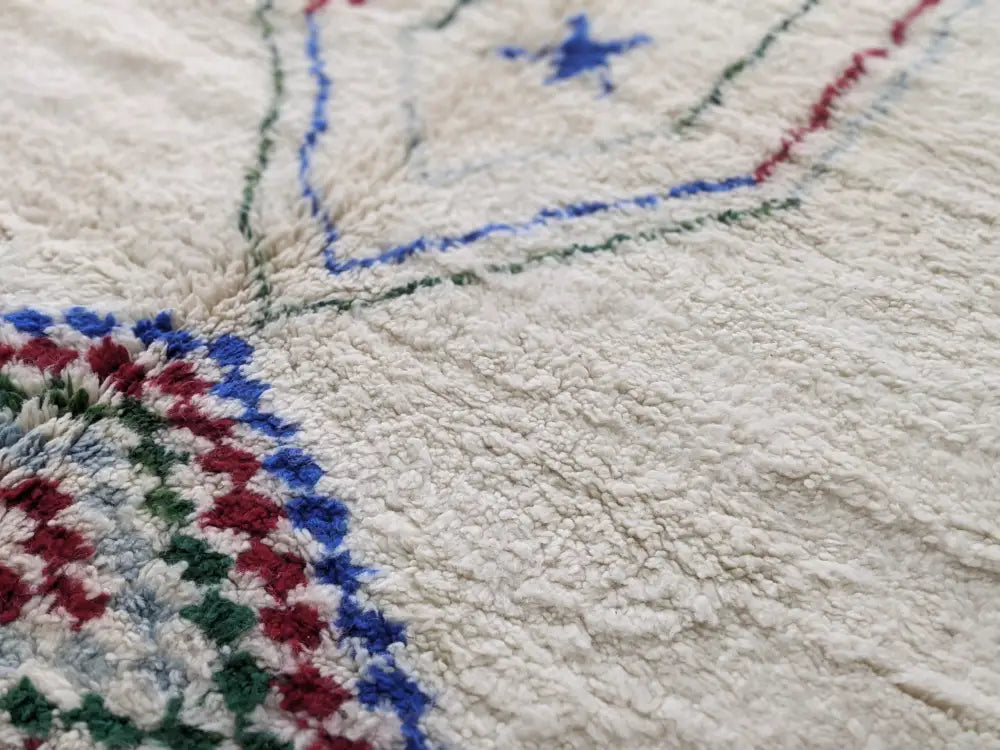 Cream-colored decorbites™ moroccan handmade traditional azilal rug with intricate blue green and red wool geometric patterns 300 x 210 cm