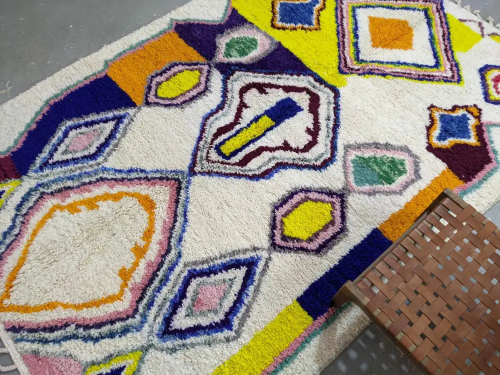 Vibrant moroccan handmade traditional azilal rug with plush multicolored tufting in white yellow blue pink and green