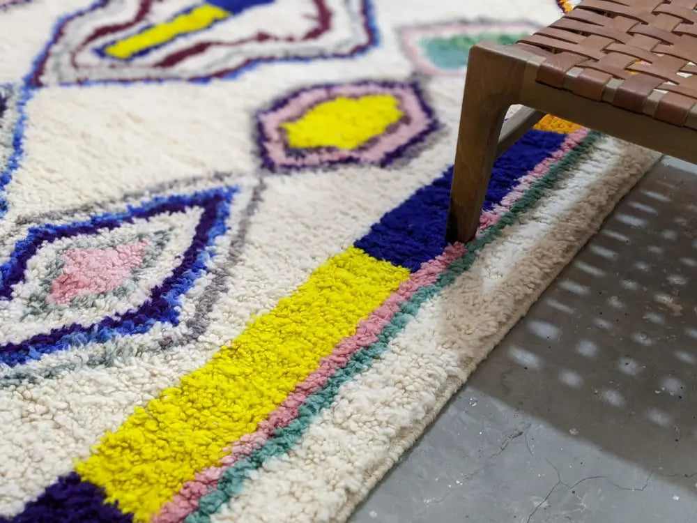 Vibrant moroccan handmade traditional azilal rug with fluffy wool and geometric patterns in yellow blue pink and purple