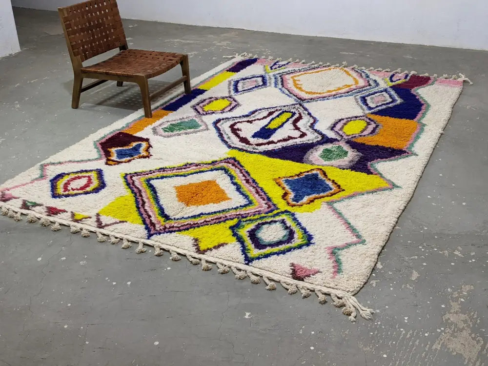 Vibrant moroccan handmade traditional azilal rug with colorful geometric wool motifs on a cream base 308 x 212 cm