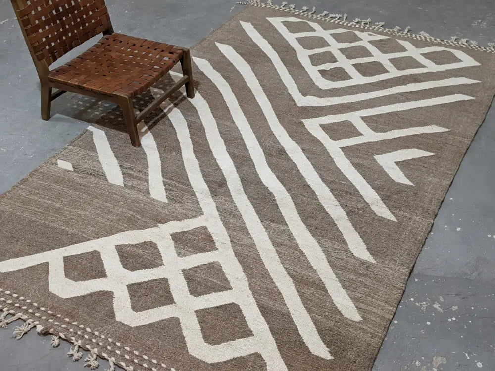 Brown woven moroccan handmade traditional azilal rug with bold white geometric patterns and fringed edges 309 x 200 cm
