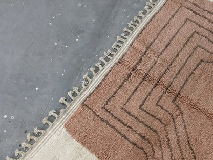 A plush terracotta moroccan handmade traditional azilal rug with a geometric zigzag pattern and cream fringe edge