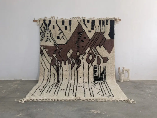 Beige and brown geometric-patterned moroccan handmade traditional azilal rug with black accents and fringed edges by DecorBites