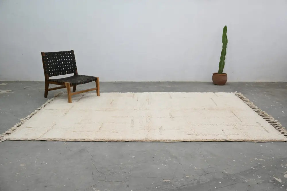 Cream-colored beni ouarain carpet with minimalist geometric pattern handwoven from wool moroccan handmade rug