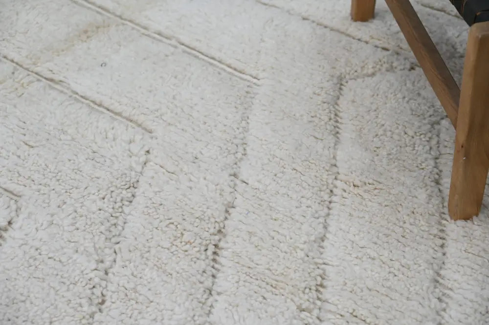 Cream-colored plush shaggy beni ouarain rug with textured looped pile and subtle vertical striping 285 x 205 cm
