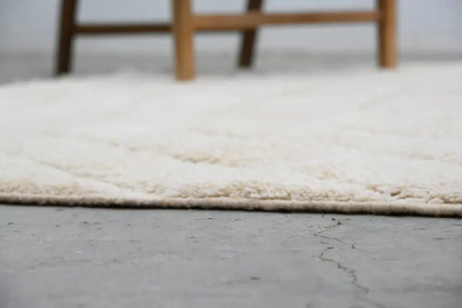 Cream-colored plush shaggy beni ouarain rug with soft textured surface and neatly finished edges by DecorBites™
