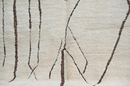 DecorBites™ Moroccan handmade traditional beni ouarain rug with cream wool and dark brown geometric patterns