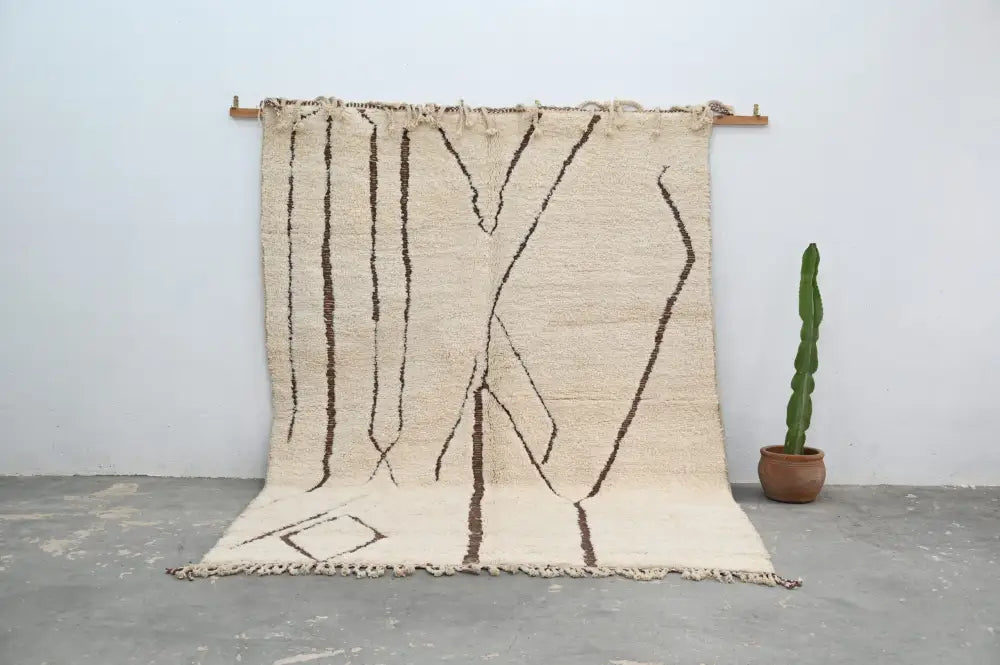 Beige beni ouarain rug with dark brown geometric patterns and fringed edges from decorbites™ handmade collection