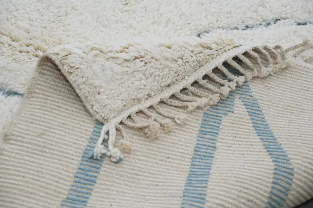 Cream-colored beni ouarain rug with soft fluffy texture and light blue geometric stripes moroccan handmade 300 x 205 cm