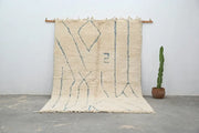 Cream-colored moroccan handmade beni ouarain rug with muted blue geometric patterns and fringed woolen texture 300 x 205 cm