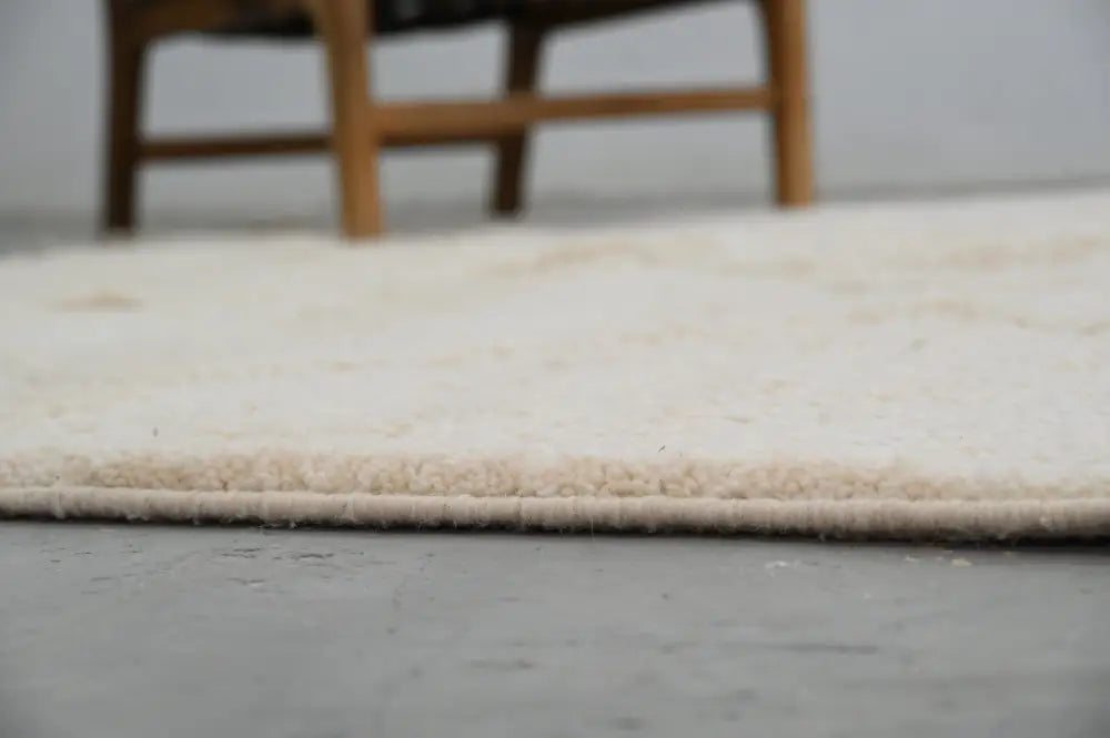 Cream-colored plush shag moroccan handmade beni ouarain rug with soft textured surface and neatly finished edge
