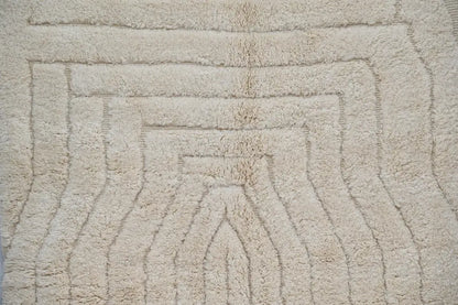 Beige plush decorbites moroccan handmade beni ouarain rug with soft textured surface and concentric arch pattern