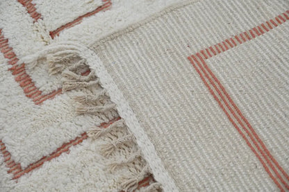 Cream-colored moroccan handmade beni ouarain rug with terracotta geometric patterns and fringed edge 302 x 200 cm