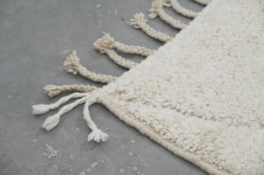 Cream-colored plush shaggy beni ouarain rug with textured surface and braided tassels moroccan handmade 302 x 200 cm
