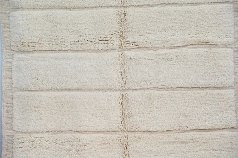 Beige plush beni ouarain rug with textured terry cloth surface and horizontal ribbed stripes by decorbites