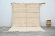 Cream-colored handwoven beni ouarain rug with chunky knit texture and fringed edges by DecorBites™ 303 x 205 cm