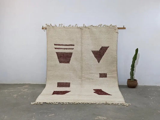 Beige moroccan handmade beni ouarain rug with rust geometric patterns and fringed edges from decorbites