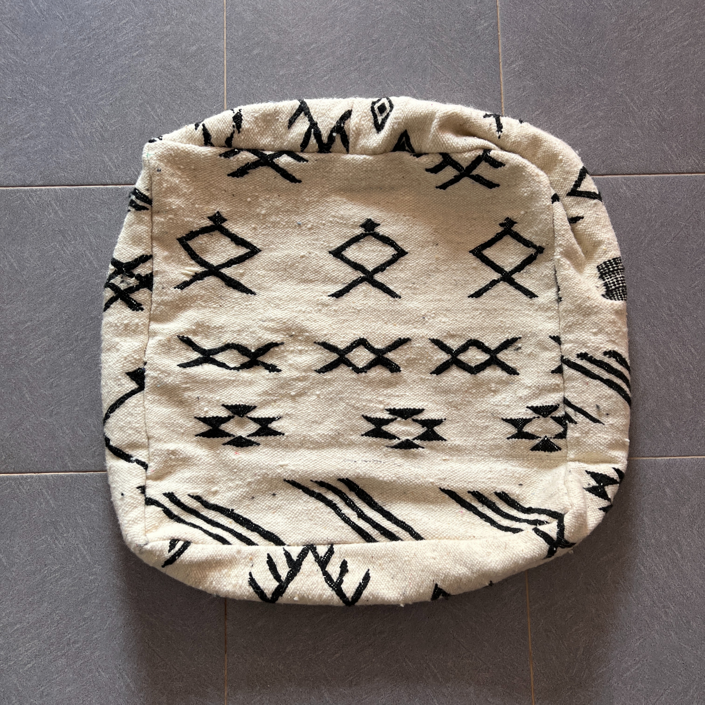 Cream-colored decorbites moroccan handmade pouf with black geometric patterns 60cm x 60cm traditional cushion