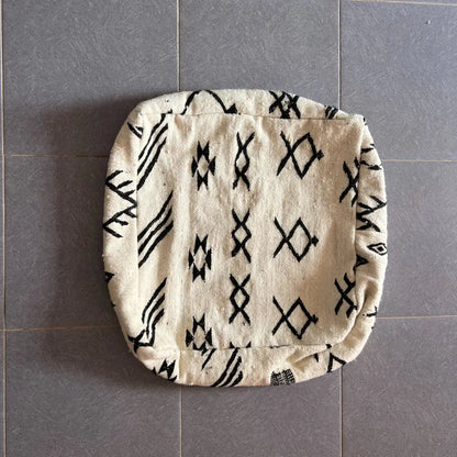 Cream-colored decorbites moroccan handmade pouf 60cm x 60cm with black geometric woven textile design