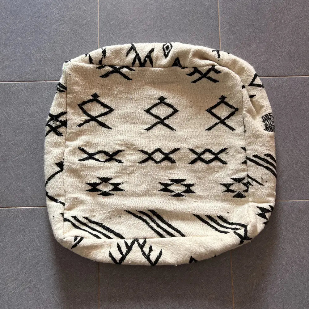 Cream-colored decorbites moroccan handmade pouf with black geometric patterns 60cm x 60cm traditional cushion