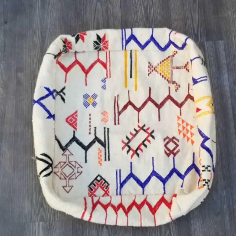 A decorbites moroccan handmade 60cm x 60cm off-white cushion with vibrant embroidered geometric patterns