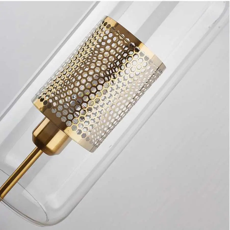 DecorBites™ modern bathroom wall sconce with gold-toned honeycomb cylindrical lampshade encased in clear glass