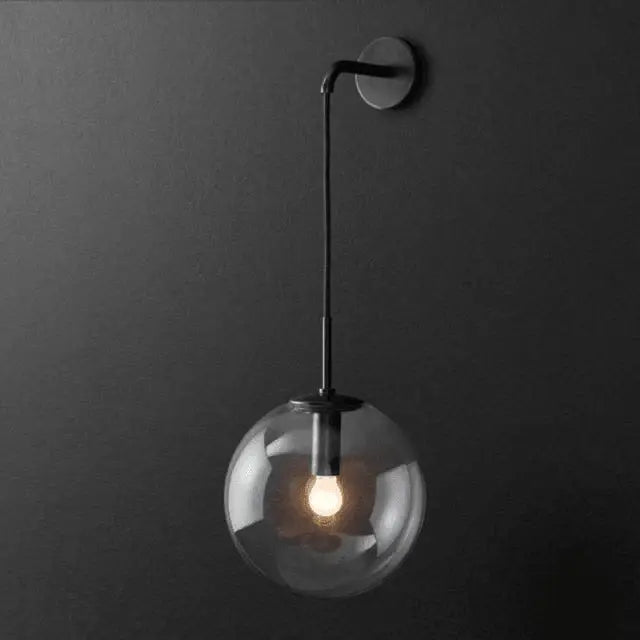 Decorbites™ moroccan modern wall sconce light with sleek black metal frame and clear glass globe housing illuminated bulb