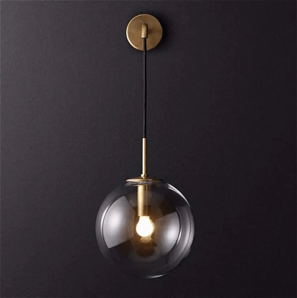 DecorBites™ Moroccan modern wall sconce light with a sleek clear glass globe and brass accents modern wall sconce