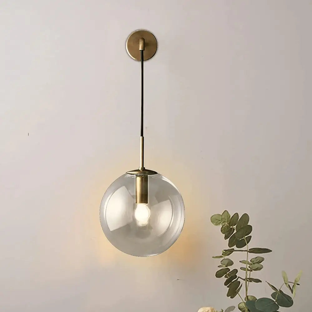 DecorBites™ Moroccan modern wall sconce featuring a spherical glass pendant light with brass finish and black cord