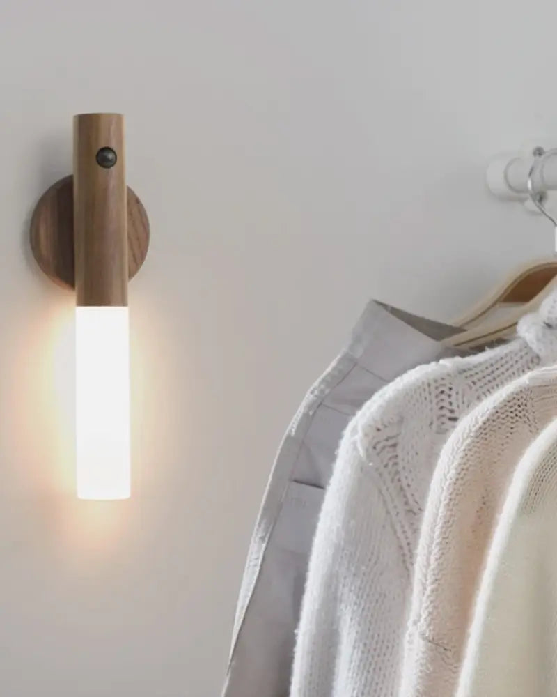 A sleek decorbites moroccan rechargeable battery-operated wall sconce with a warm glow and natural wood finish