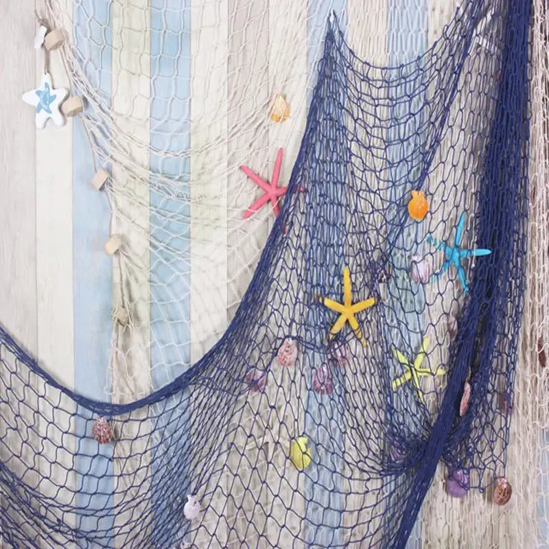 DecorBites™ nautical theme wall decor featuring a navy and cream fishing net decoration with colorful starfish and seashells
