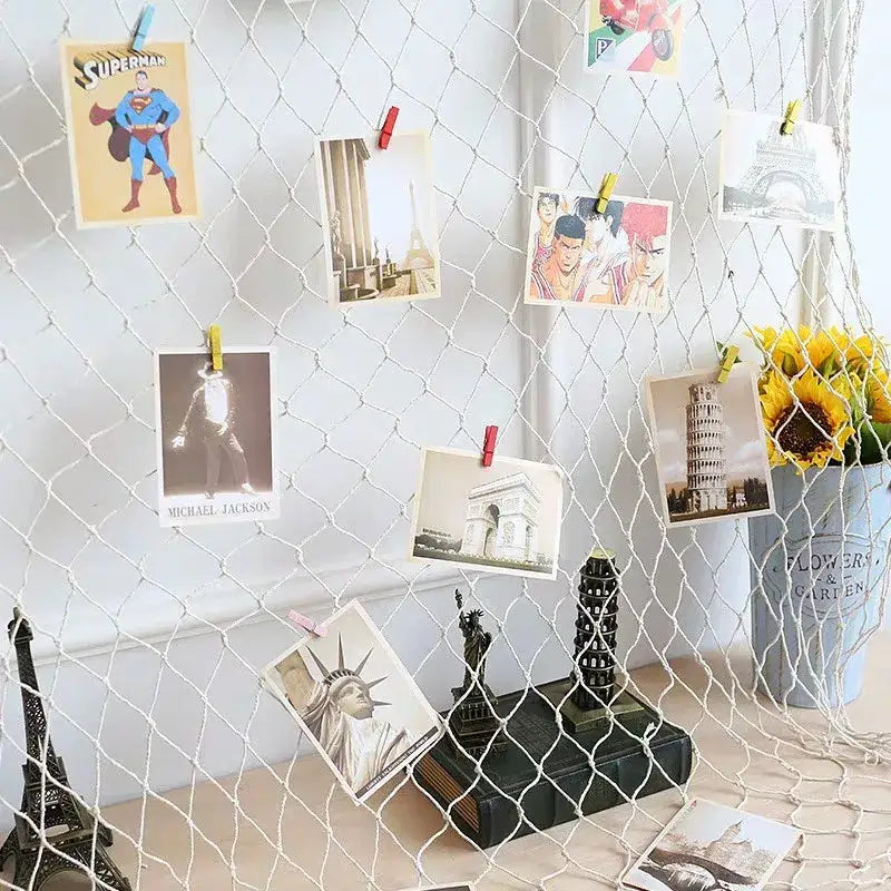White mesh fishing net decoration with colorful photos clipped for DecorBites™ nautical theme wall decor
