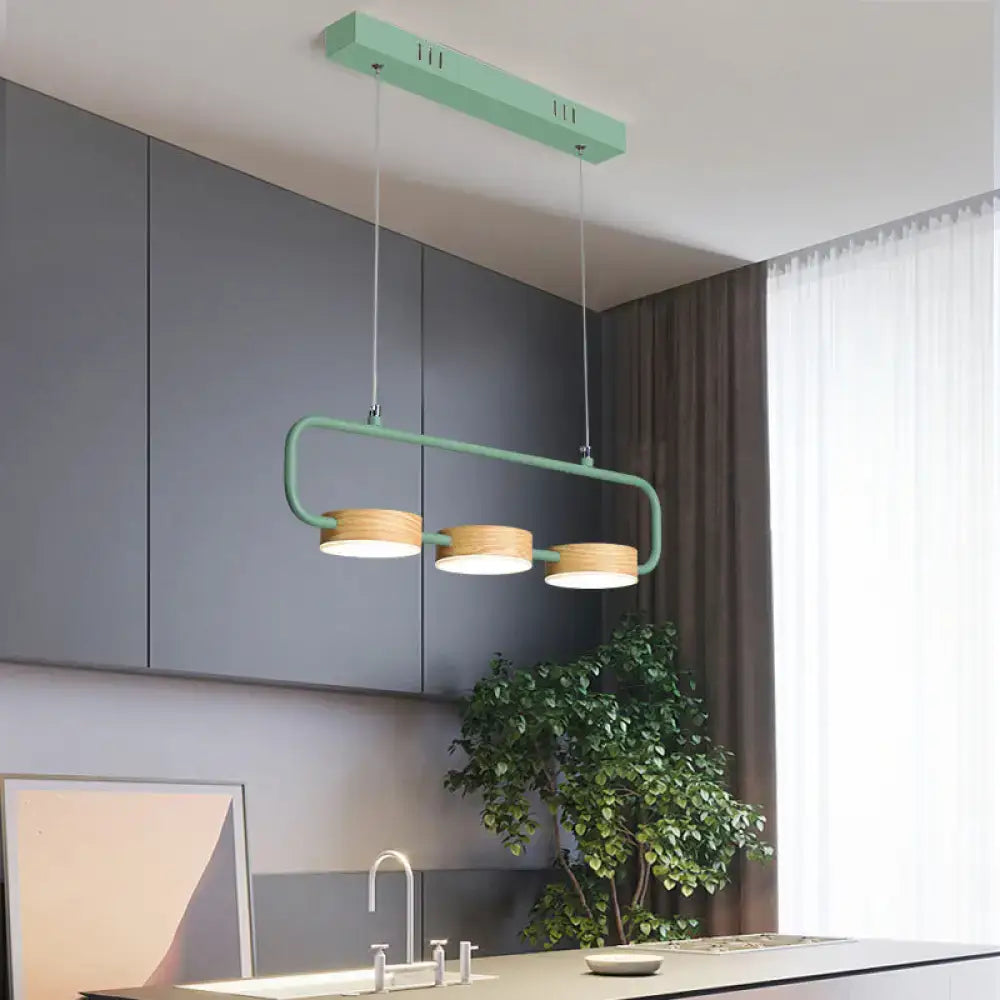 Modern mint green DecorBites™ 3-light hanging pendant with wooden shades and metal accents for kitchen island lighting