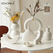 White ceramic nordic ceramic vase with minimalist sculptural design smooth surface for home decor accent by DecorBites