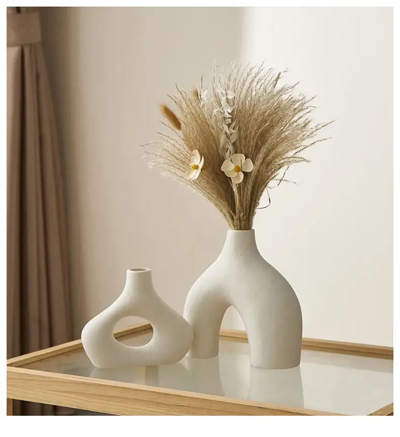 A sleek off-white nordic ceramic vase with a modern arched base and smooth curves for vases home decor