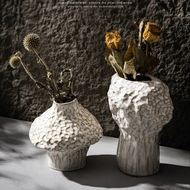Two white textured nordic ceramic vases with organic irregular shapes and rough surfaces in decorbites™ style