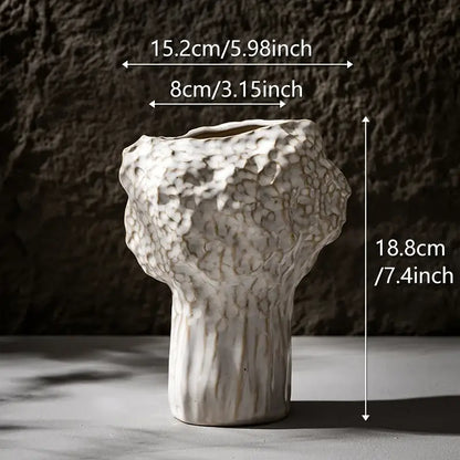 White ceramic nordic ceramic vase by DecorBites with textured organic surface and vertical ridges on base with pampas grass