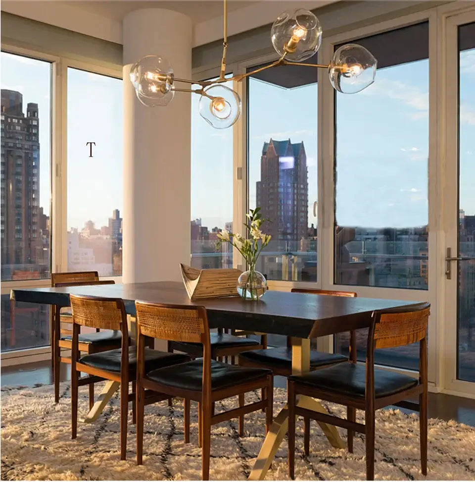 Modern dining table with dark wood top, light wooden legs, matching woven chairs, under decorbites™ nordic chandelier hanging light fixture for living room