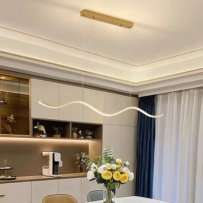 A sleek DecorBites™ pendant light with warm white LED and curved design perfect for dining room decor