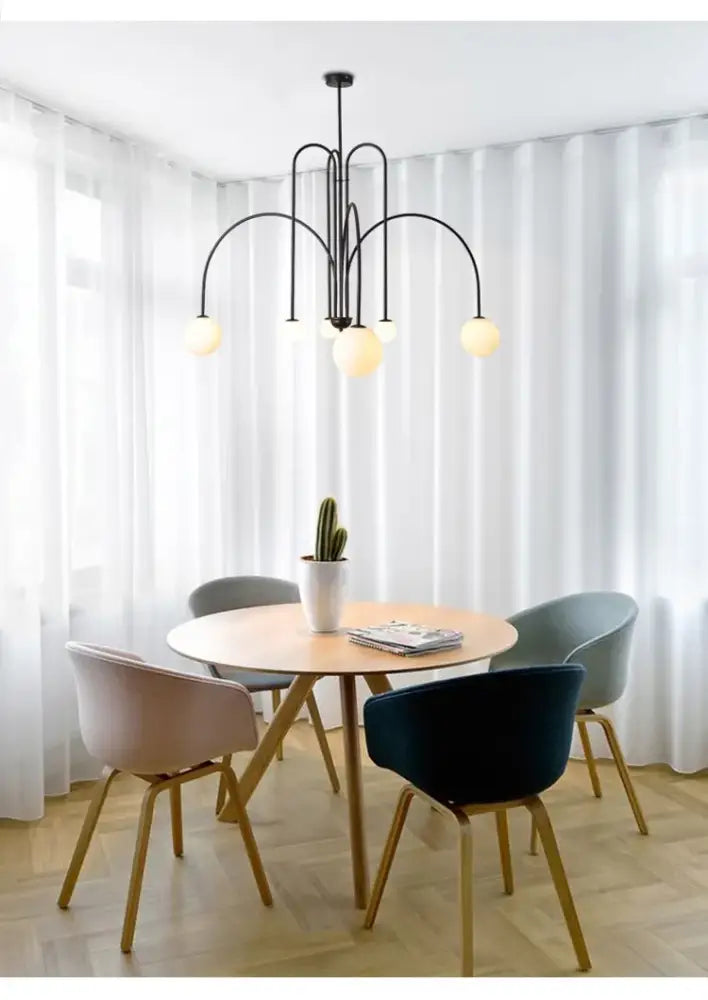 Black metal comet chandelier nordic with curved arms and spherical frosted glass shades for elegant home décor