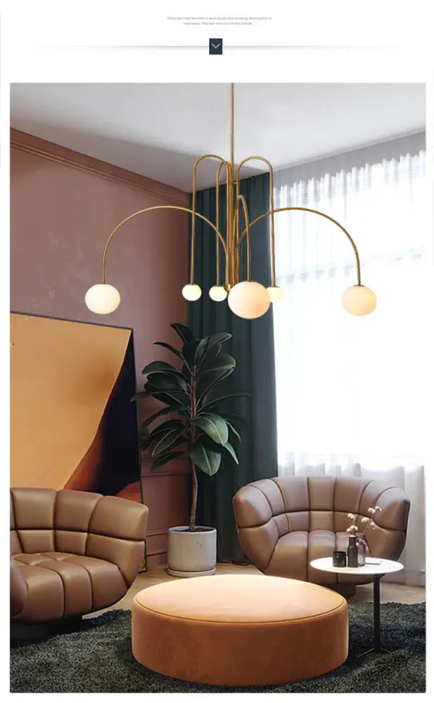 Gold-toned comet chandelier nordic with curved arms and spherical frosted glass shades for elegant home décor
