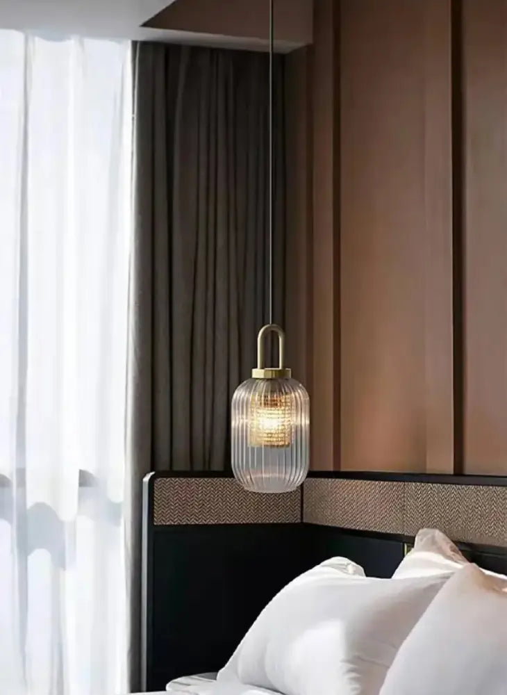 A modern pendant light with ribbed clear glass shade and brass metal accents complements the decorbites nordic deer head wall lamp