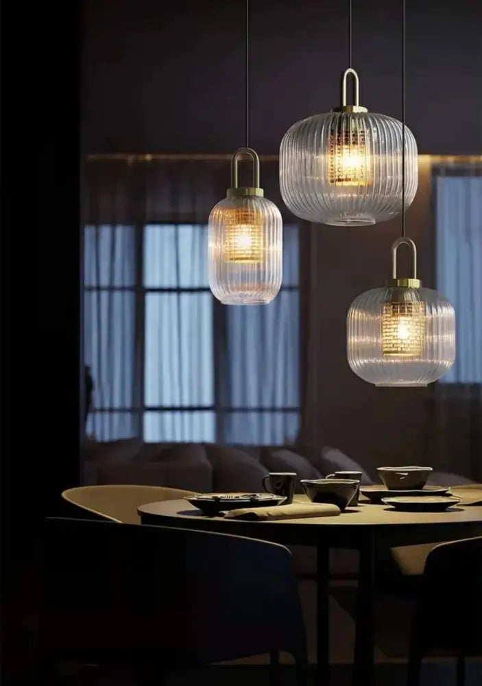 Three elegant glass pendant lights with vertical ridges and brass accents complement the decorbites nordic deer head wall lamp vintage resin wall lamp