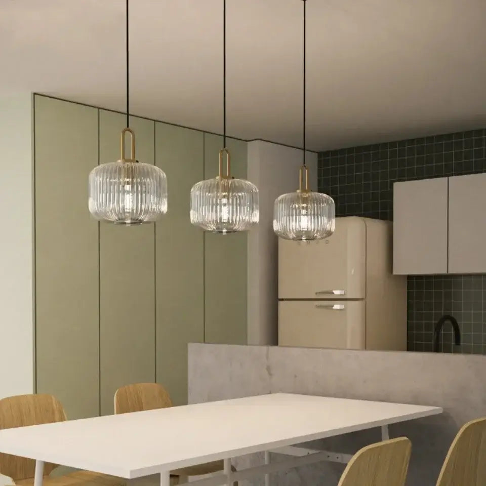 Three elegant glass pendant lights with brass accents complement the DecorBites™ nordic deer head wall lamp resin decor
