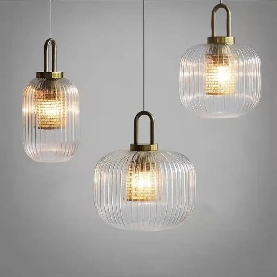 Three elegant ribbed glass pendant lights with brass accents complement the decorbites™ nordic deer head wall lamp vintage resin head wall lamp