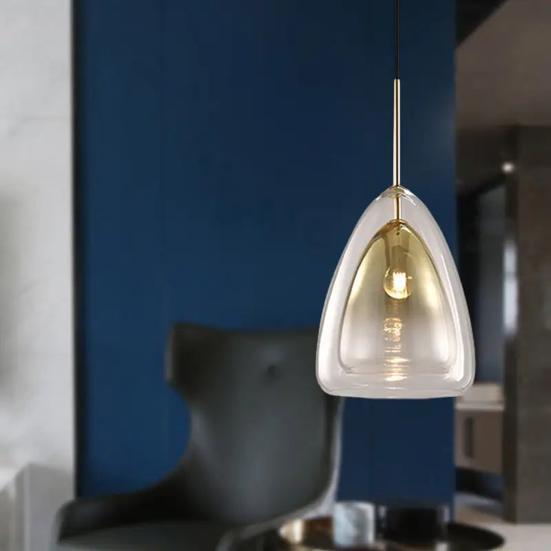 DecorBites Nordic pendant light fixture with clear teardrop glass shade and gold-toned metal stem in champagne finish