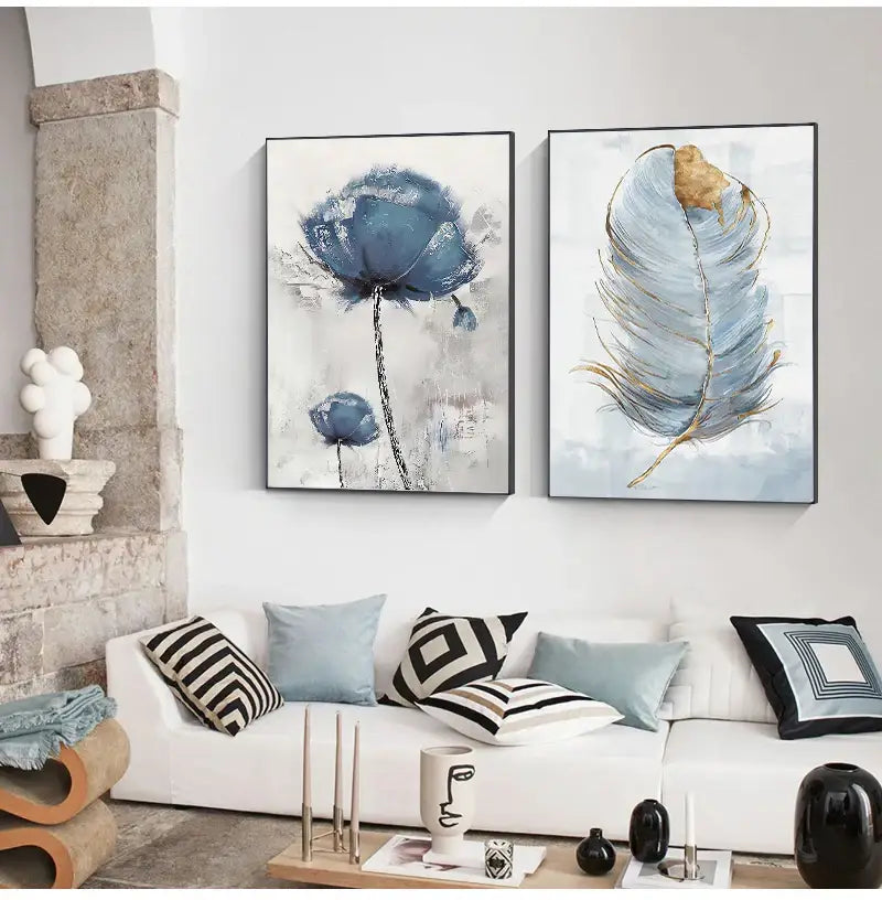 Two framed canvas art prints featuring a nordic flower abstract and a blue feather with gold accents by decorbites™